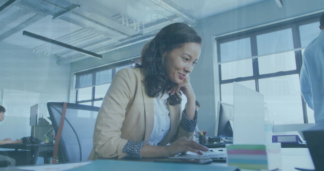 Professional Woman Using Laptop in Modern Office Environment