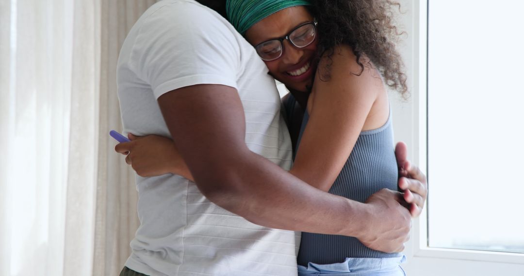 Couple Embracing While Celebrating Positive Pregnancy Test News