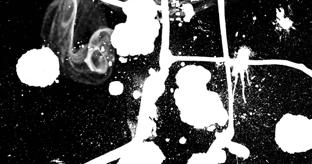 Abstract White Paint Splatter Pattern on Black Canvas