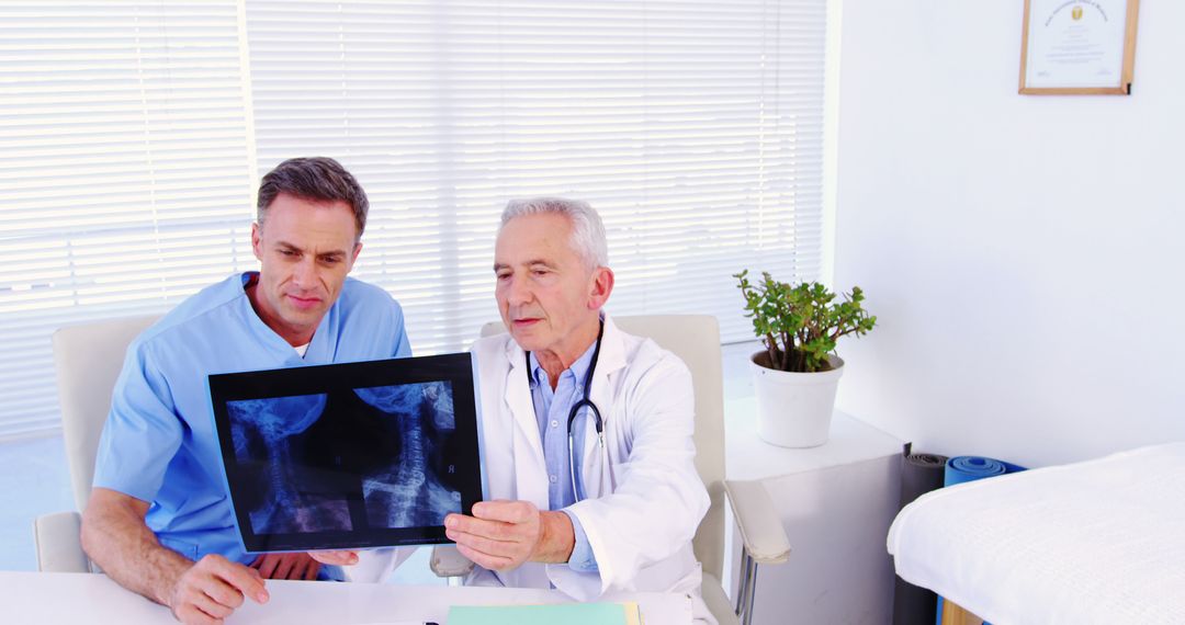 Doctor and Medical Staff Examining X-Ray Results Together - Free Images, Stock Photos and Pictures on Pikwizard.com