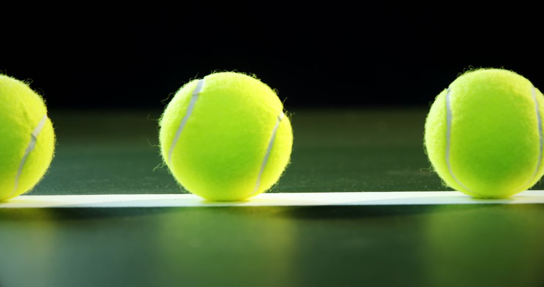 Three Tennis Balls in a Line on Black Background - Free Images, Stock Photos and Pictures on Pikwizard.com