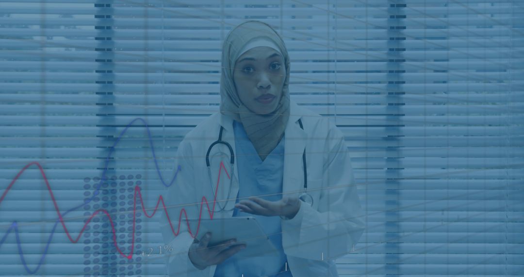 Hijab-Wearing Doctor Analyzing Medical Data on Tablet