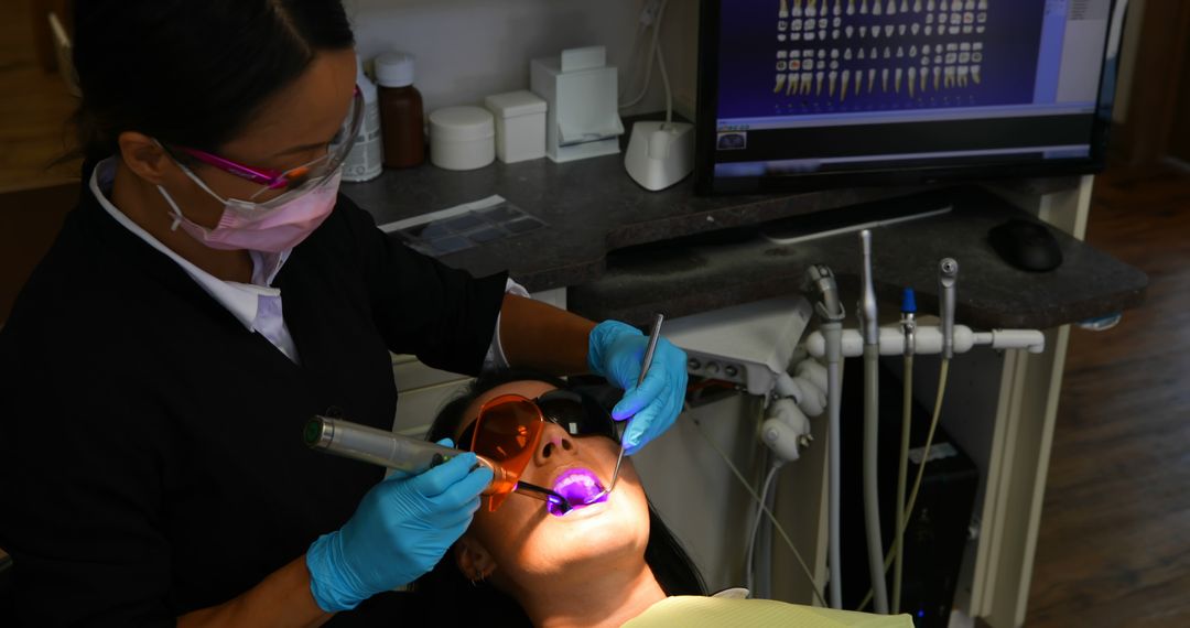 Dentist Using Ultraviolet Light on Patient for Dental Procedure - Free Images, Stock Photos and Pictures on Pikwizard.com