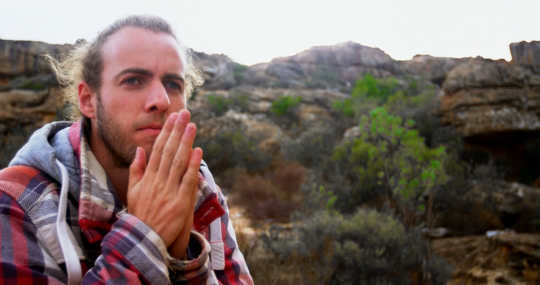 Man Reflecting Outdoors in Beautiful Rocky Landscape - Free Images, Stock Photos and Pictures on Pikwizard.com