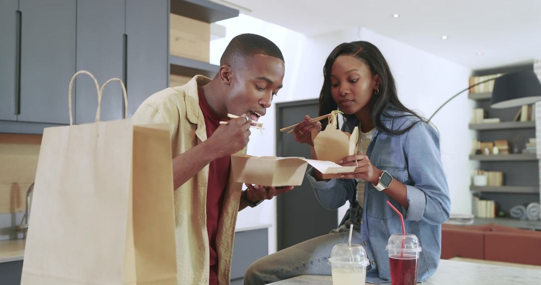 Couple Enjoying Asian Takeout Together at Home