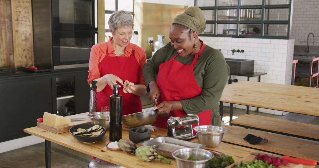 Two Women Preparing Meal Together in Modern Kitchen - Free Images, Stock Photos and Pictures on Pikwizard.com