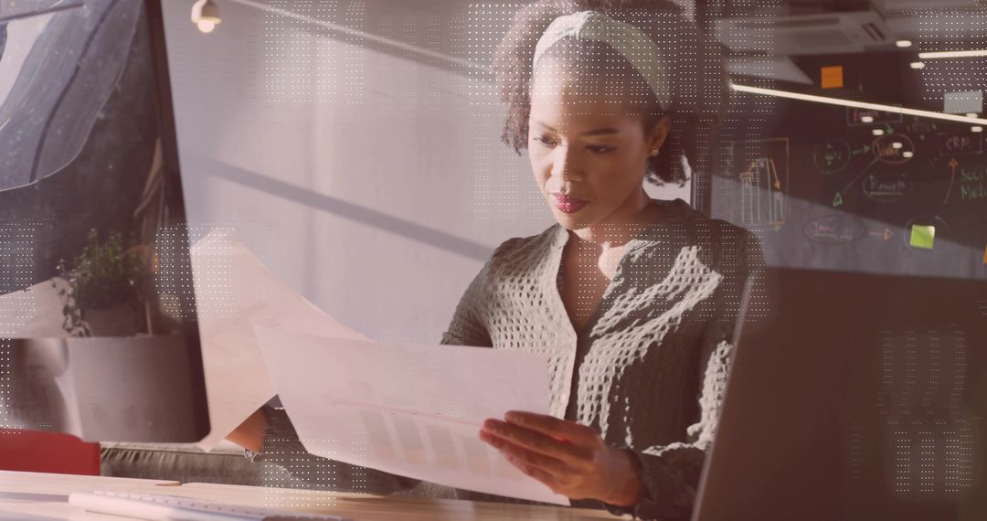 Professional Woman Analyzing Financial Documents in Modern Office