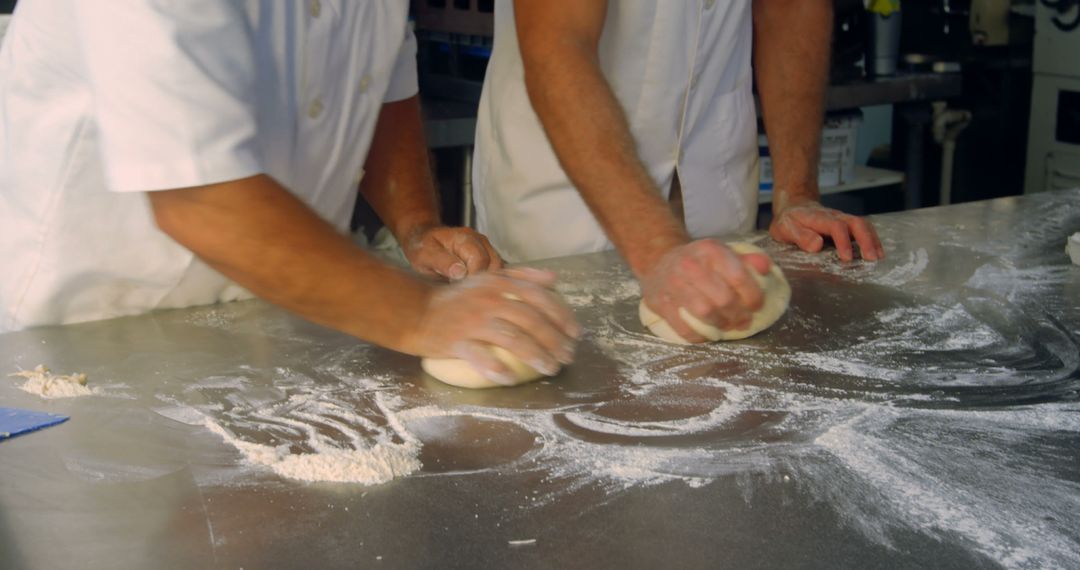 Bakers Kneading Dough on Metal Countertop - Free Images, Stock Photos and Pictures on Pikwizard.com