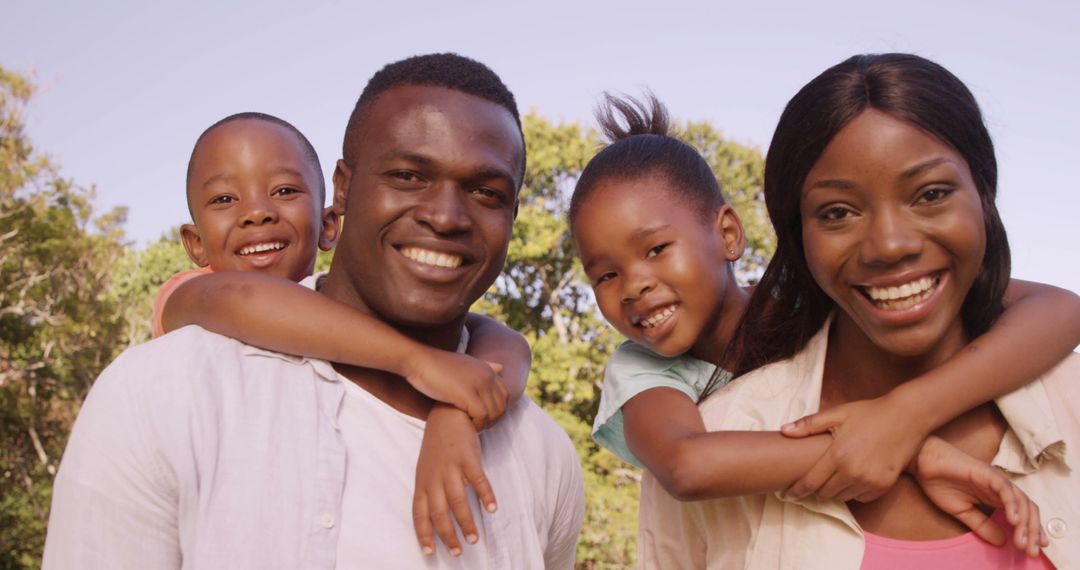 Happy African American Family Smiling Outdoors - Free Images, Stock Photos and Pictures on Pikwizard.com