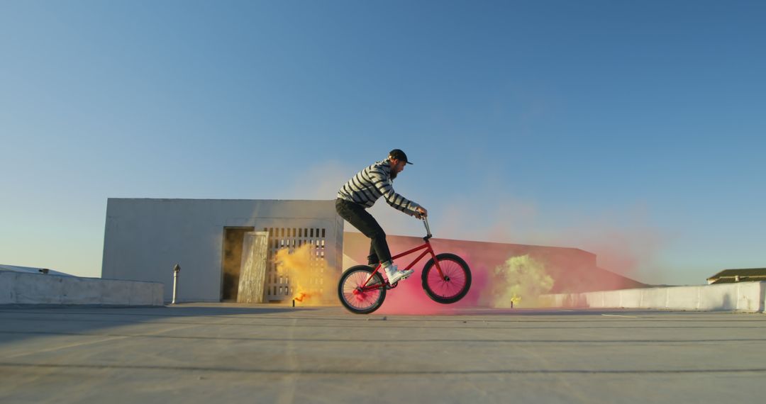 BMX Rider Performing Tricks with Colorful Smoke Outdoors - Free Images, Stock Photos and Pictures on Pikwizard.com