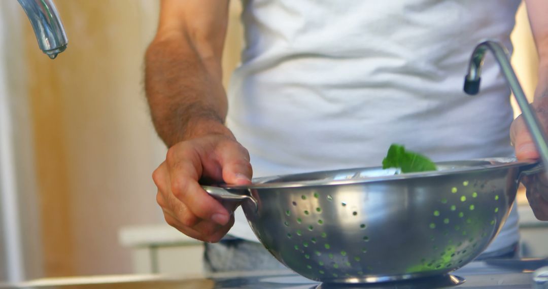 Person Washing Leafy Greens in Colander at Kitchen Sink - Free Images, Stock Photos and Pictures on Pikwizard.com