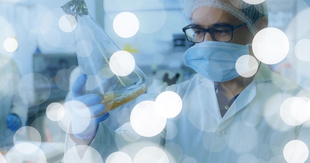 Scientist Examining Yellow Liquid in Lab Flask