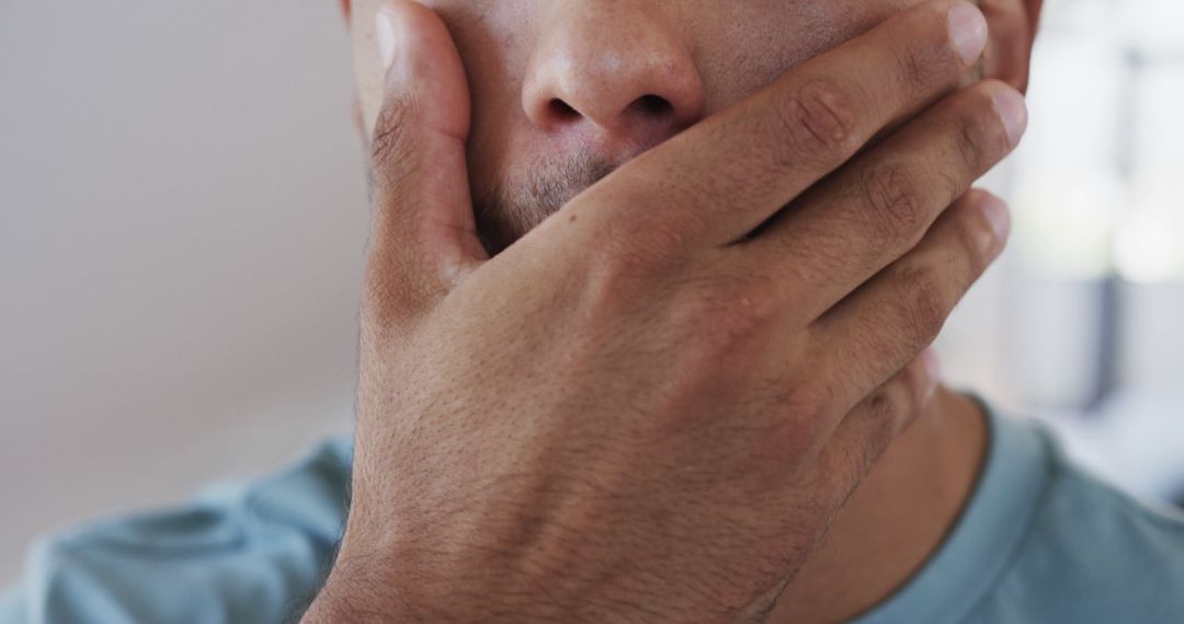 Close-Up of Person Covering Mouth with Hand in Thoughtful Expression - Free Images, Stock Photos and Pictures on Pikwizard.com