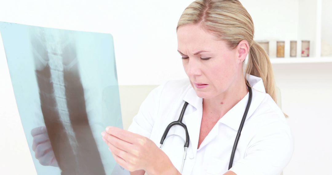 Female Doctor Examining X-ray with a Concentrated Expression - Free Images, Stock Photos and Pictures on Pikwizard.com