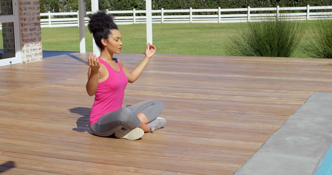 Young Woman Meditating Outdoors on Wooden Deck - Free Images, Stock Photos and Pictures on Pikwizard.com