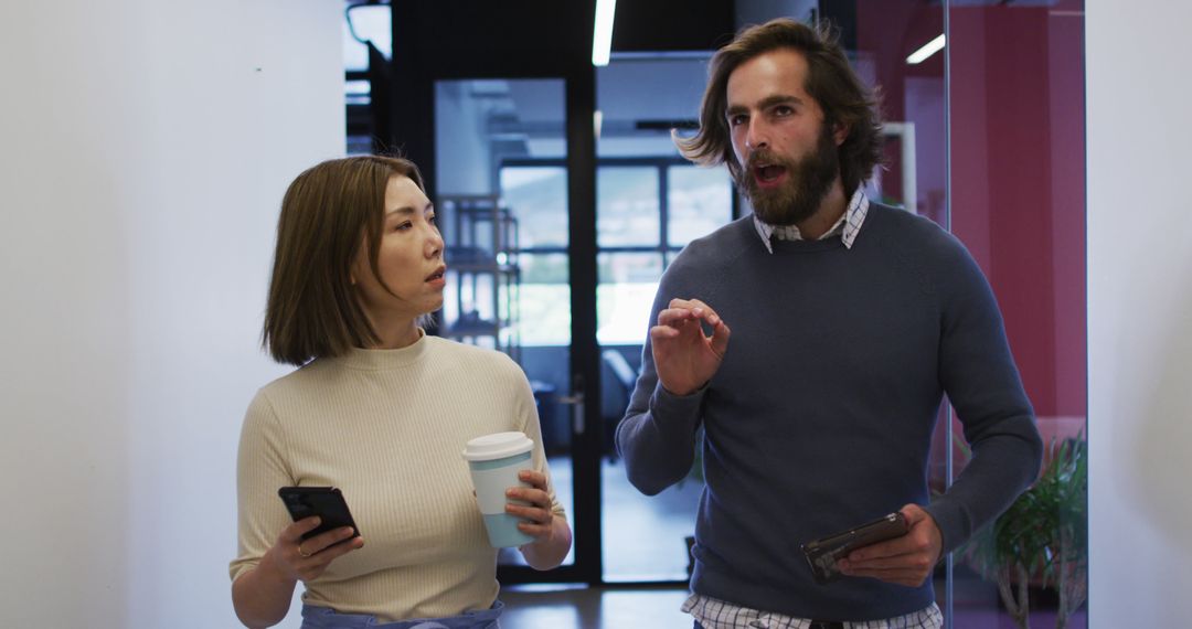 Professionals Discussing and Using Technology in Modern Workspace