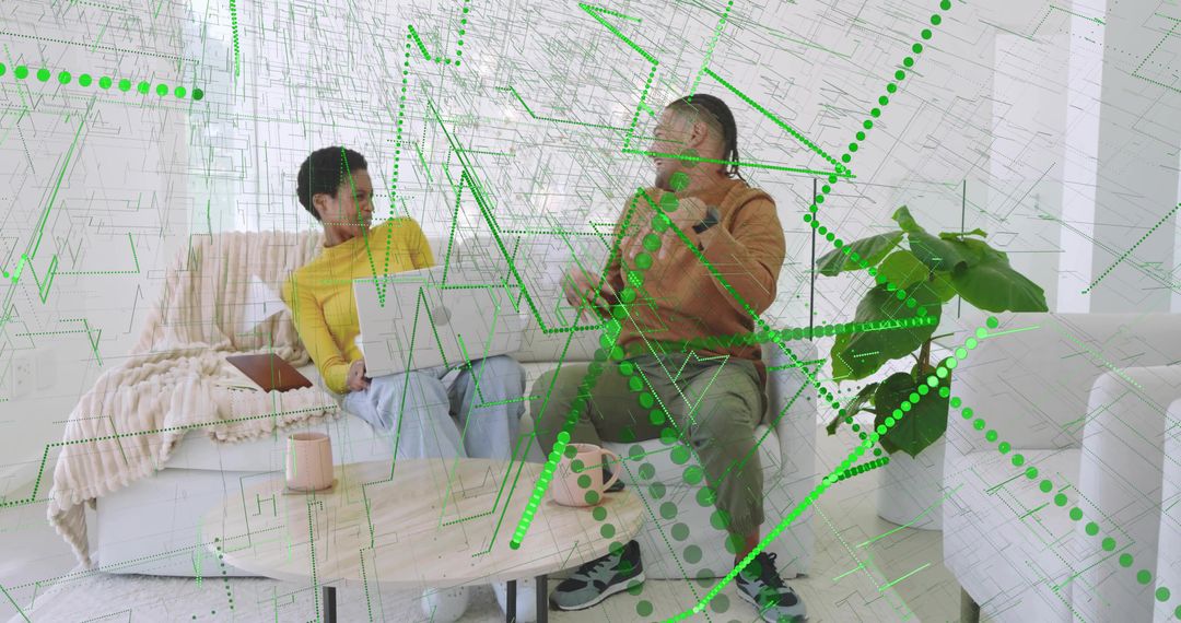 Collaborating friends using laptop and smartphone with green digital overlay in living room