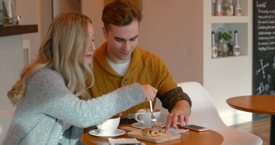 Couple Enjoying Coffee and Pastry in Cozy Cafe - Free Images, Stock Photos and Pictures on Pikwizard.com