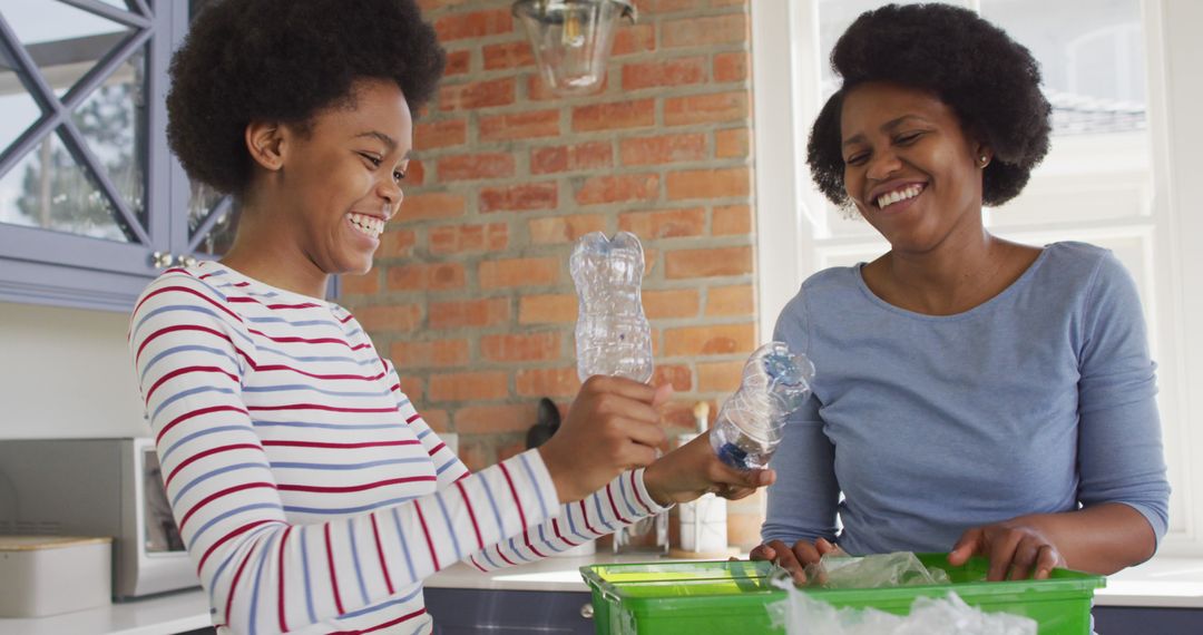 Mother and Daughter Smiling While Recycling Plastic Bottles at Home - Free Images, Stock Photos and Pictures on Pikwizard.com