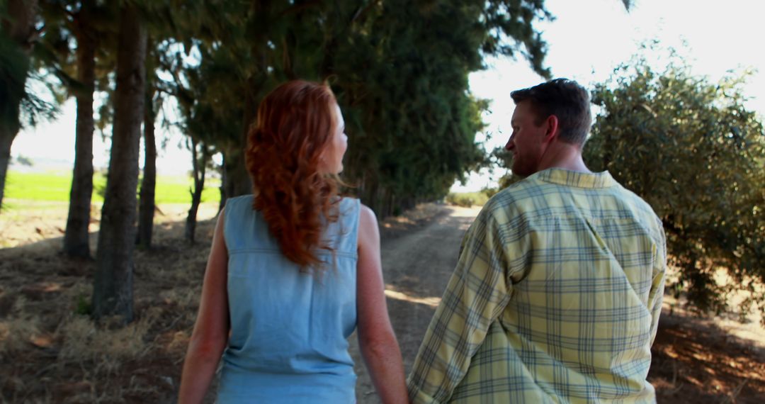 Couple Walking in Countryside Holding Hands - Free Images, Stock Photos and Pictures on Pikwizard.com