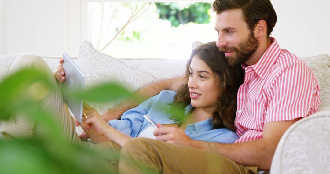 Happy Couple Relaxing with Digital Tablet at Home