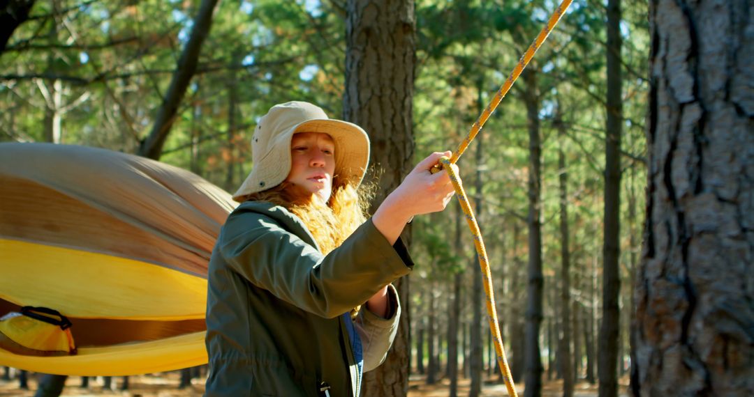 Woman Setting Up Hammock in Forest During Outdoors Adventure - Free Images, Stock Photos and Pictures on Pikwizard.com