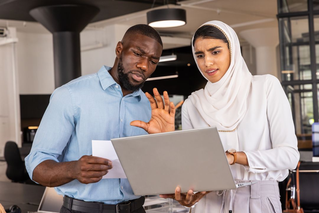 Diverse Coworkers Collaborating in Open Office Environment