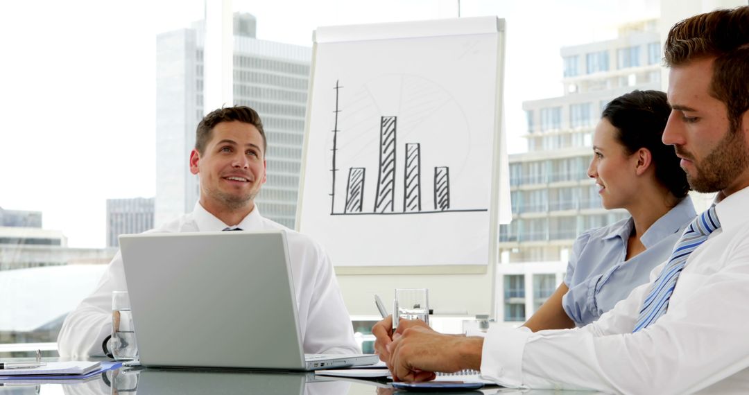 Business Team Analyzing Bar Graph Data in Modern Office - Free Images, Stock Photos and Pictures on Pikwizard.com