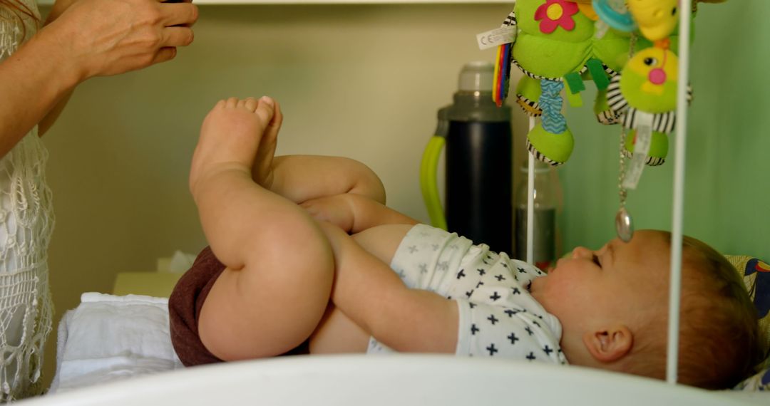 Mother Changing Toddler Diaper in Light-Filled Nursery - Free Images, Stock Photos and Pictures on Pikwizard.com