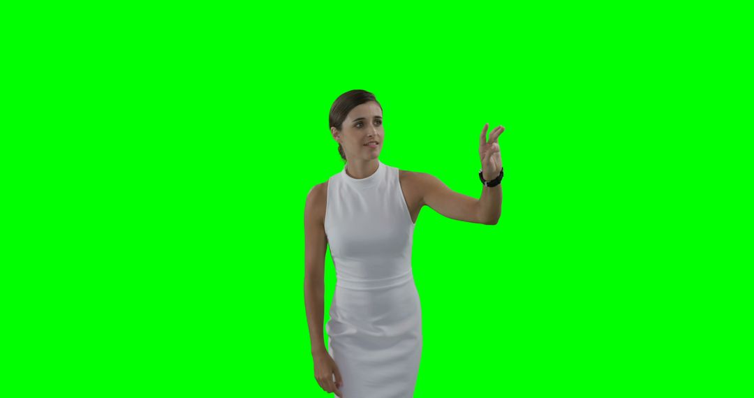 Professional Woman in White Dress Interacting with Virtual Interface on Green Screen - Free Images, Stock Photos and Pictures on Pikwizard.com