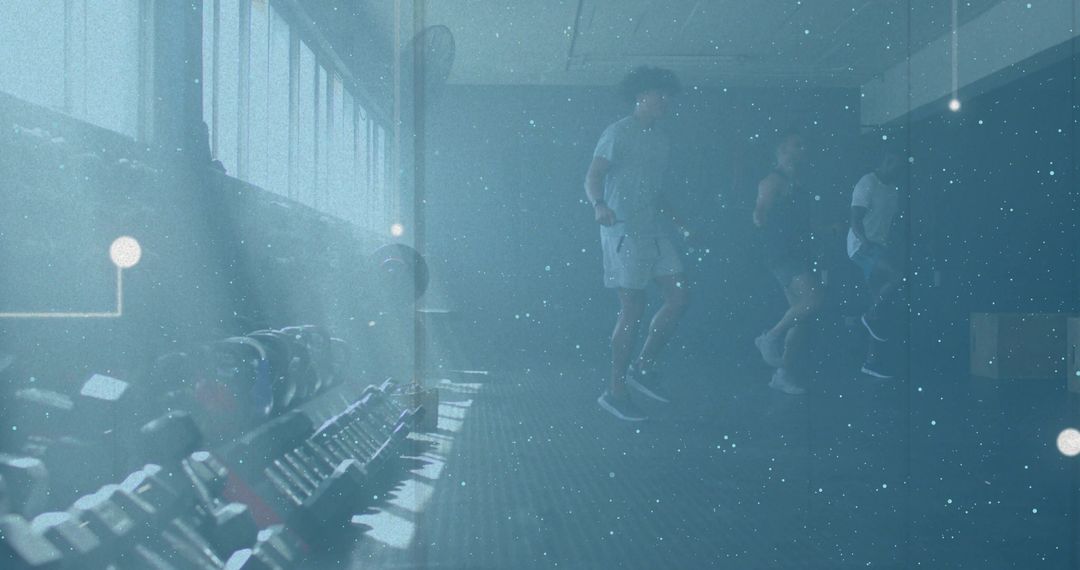 Three men training together in gym with dumbbell rack and moody blue lighting