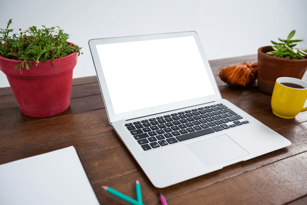 Transparent Laptop Scene with Coffee and Plants on Wooden Office Table