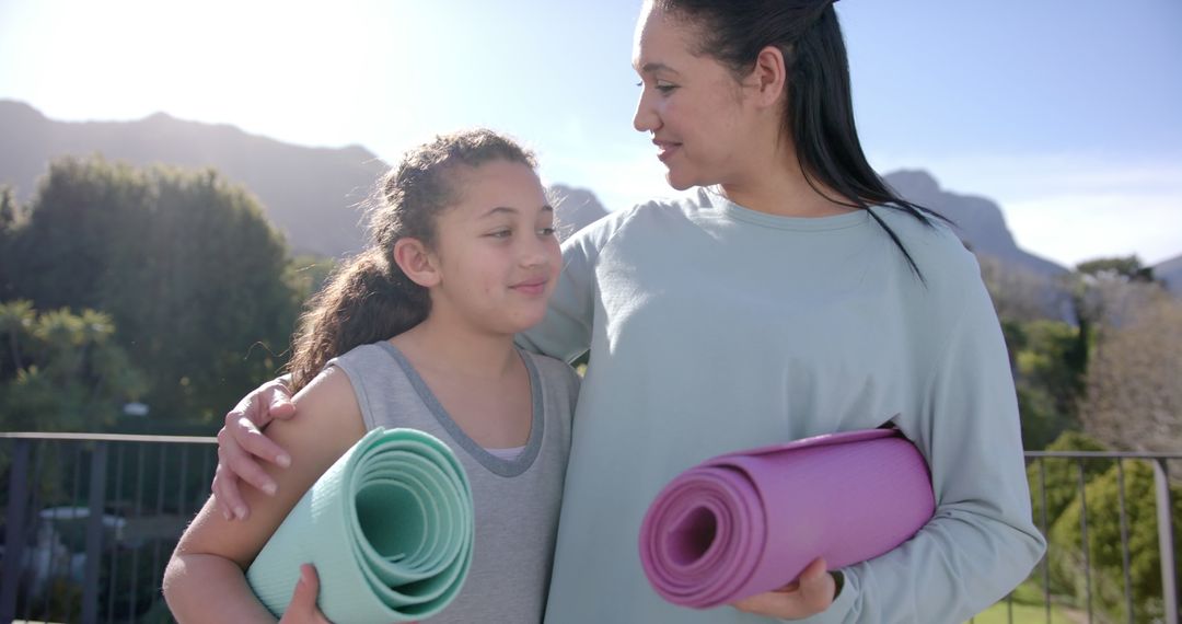 Mother and Daughter Ready for Outdoor Yoga with Mats - Free Images, Stock Photos and Pictures on Pikwizard.com