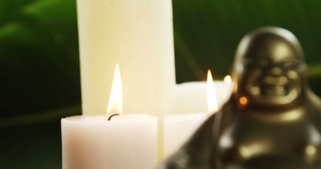 Buddha Statue and Lit Candles in Tranquil Setting - Free Images, Stock Photos and Pictures on Pikwizard.com