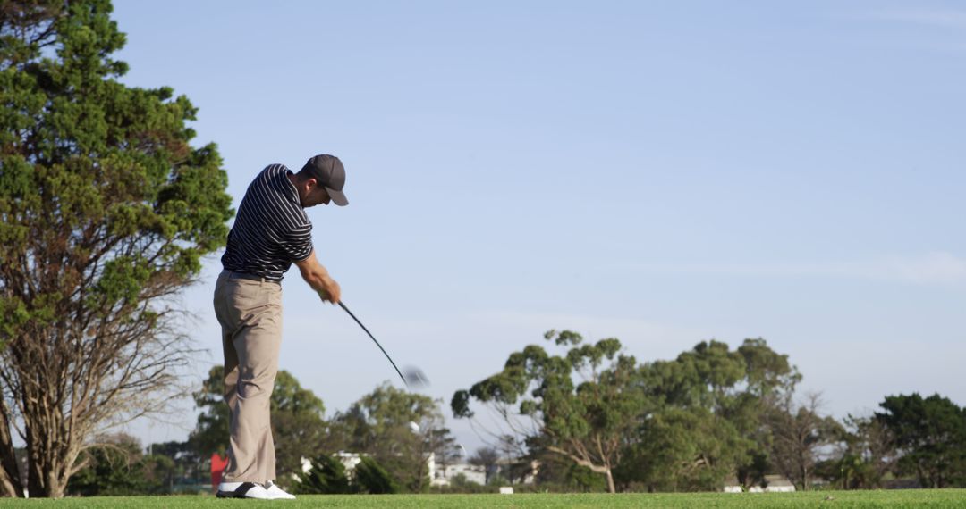 Golfer Perfecting Swing on Lush Green Course under Clear Sky