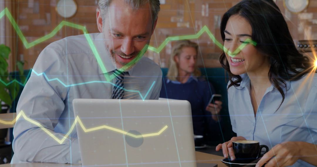 Colleagues Collaborating on Financial Data at Cafe