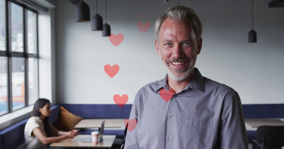 Smiling Manager with Hearts Overlay in Trendy Cafe Interior