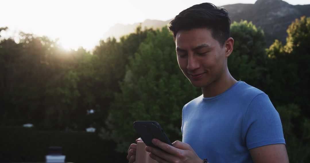 Man Enjoying Morning with Smartphone and Coffee Outdoors
