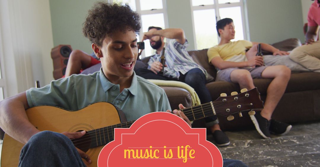 Young man passionately playing guitar among smiling friends
