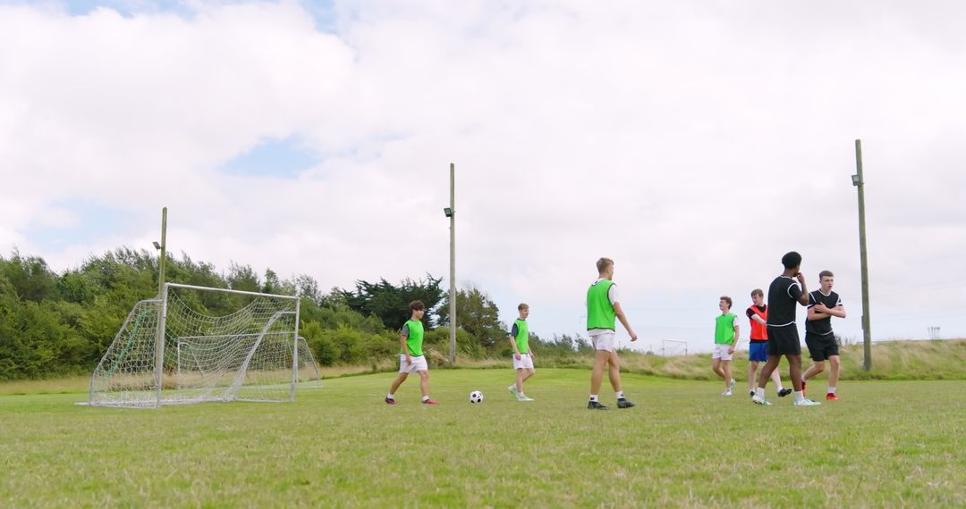 Diverse Teen Soccer Players Practicing on Green Field