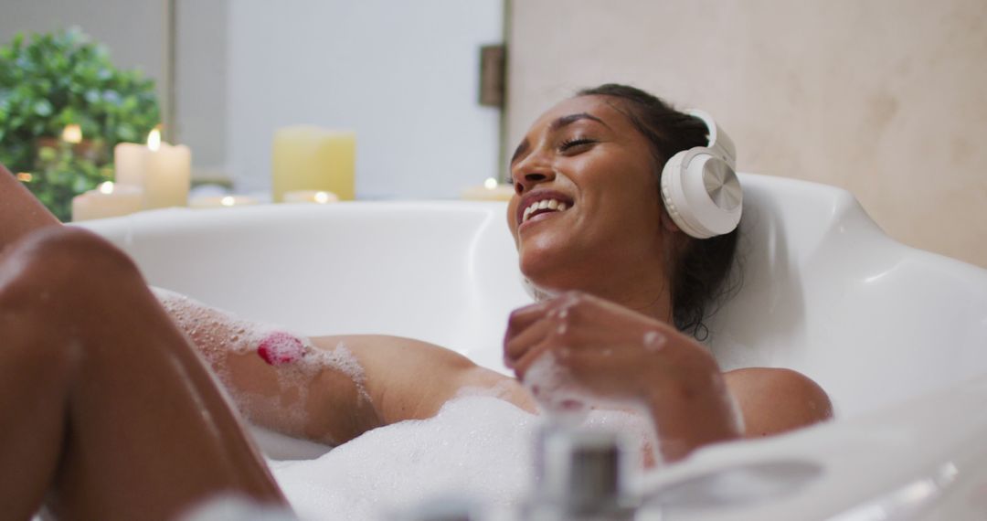 Relaxed Young Woman Listening to Music in Bubble Bath - Free Images, Stock Photos and Pictures on Pikwizard.com