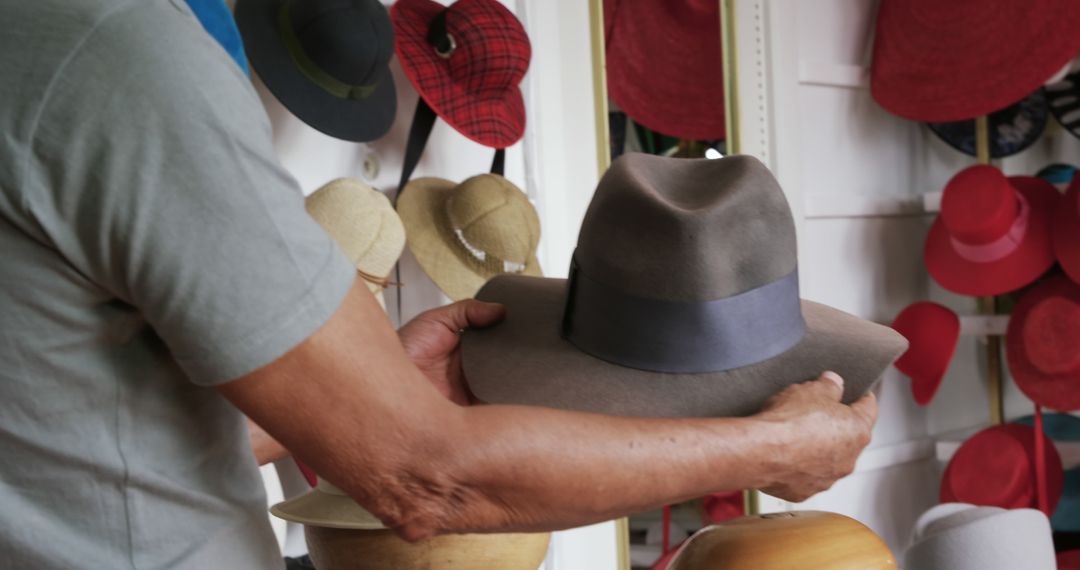 Man Choosing Fedora Hat in Boutique Store - Free Images, Stock Photos and Pictures on Pikwizard.com