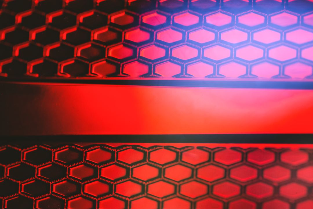 Glowing red honeycomb mesh with horizontal stripe creating futuristic tech pattern
