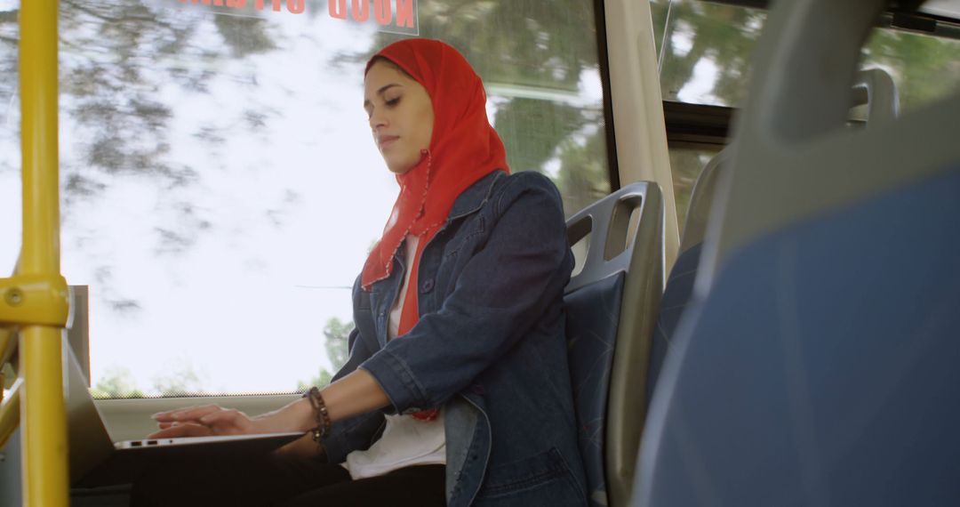 Young Muslim Woman Working on Laptop While Traveling on Bus - Free Images, Stock Photos and Pictures on Pikwizard.com