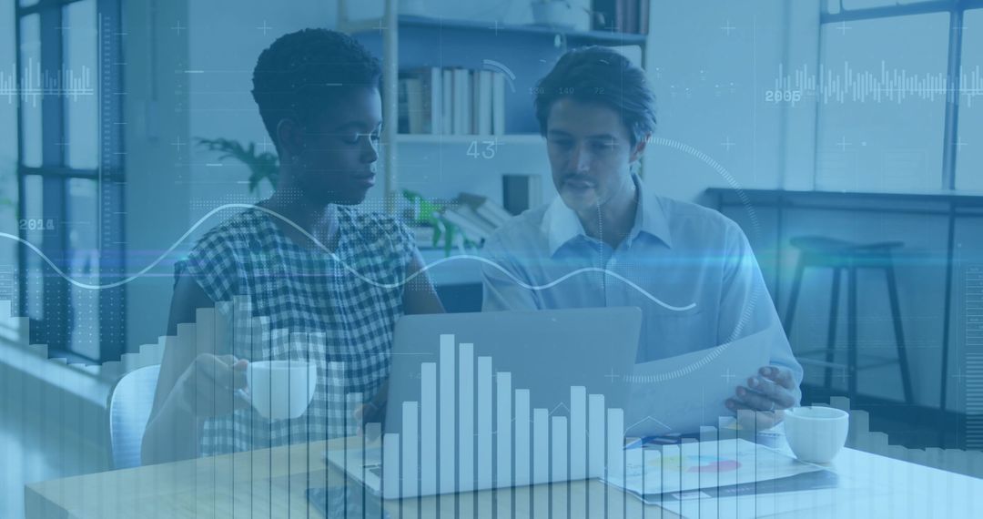 Colleagues Analyzing Digital Graphs in Modern Workspace