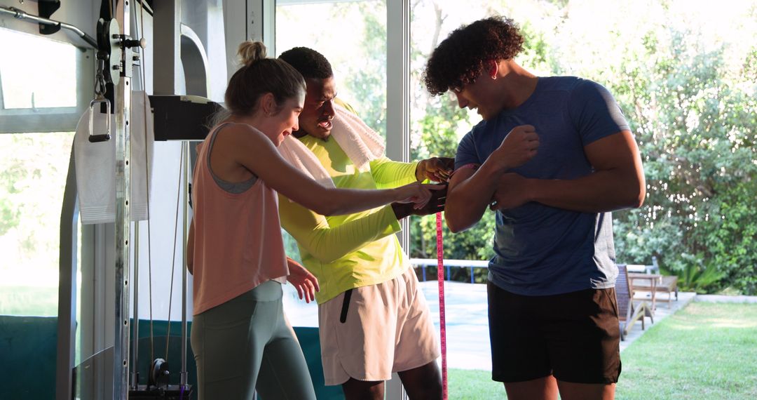 Friends Smiling and Comparing Results at Gym
