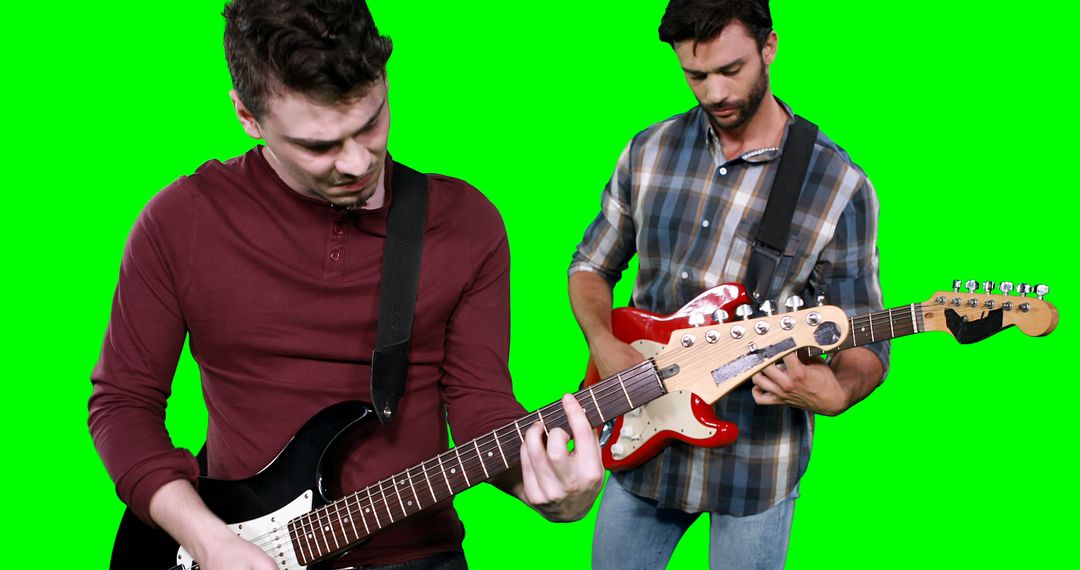 Two Men Playing Electric Guitars Against Green Screen - Free Images, Stock Photos and Pictures on Pikwizard.com