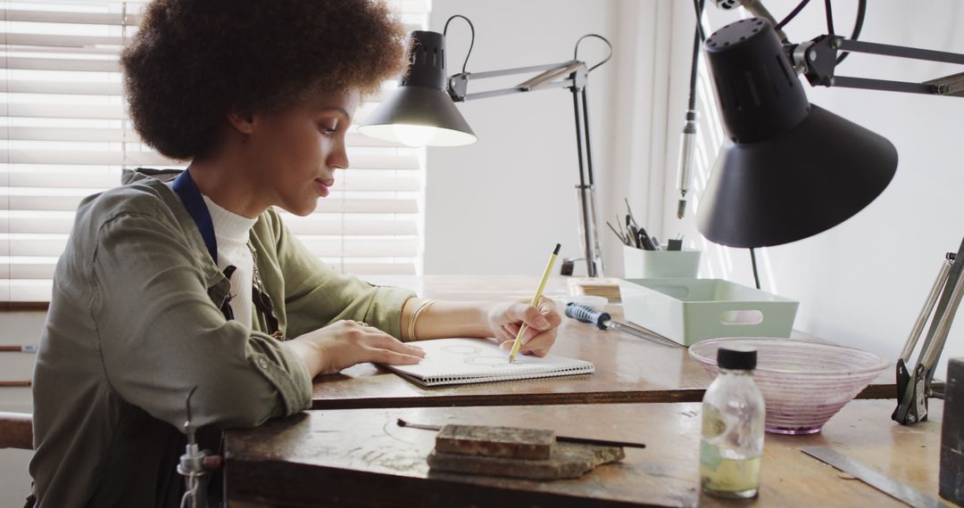 African American Female Artist Sketching in Studio - Free Images, Stock Photos and Pictures on Pikwizard.com