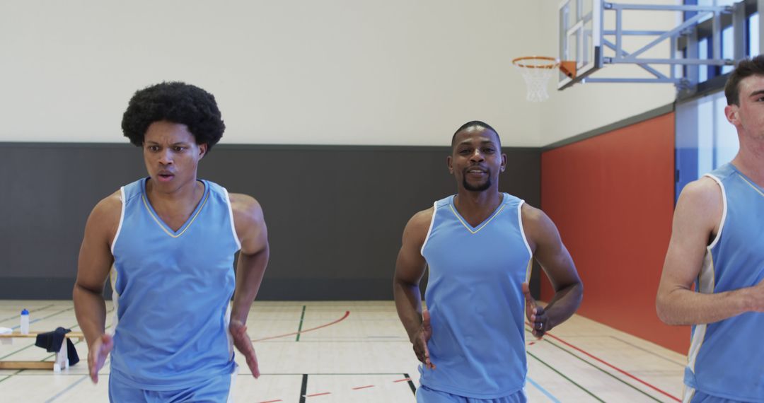 Basketball Players Exercising in Indoor Gym with Determination - Free Images, Stock Photos and Pictures on Pikwizard.com