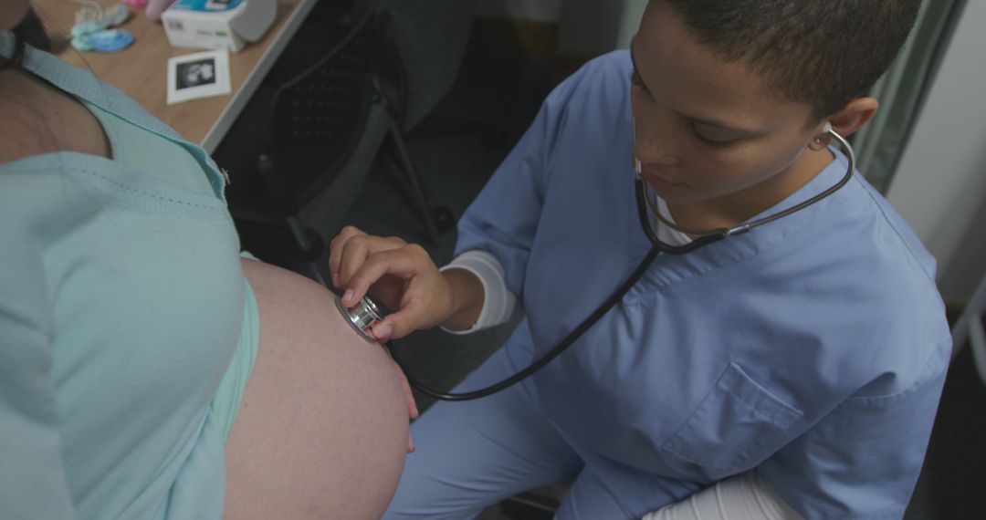 Nurse Listening to Pregnant Woman's Belly with Stethoscope in Doctor's Office - Free Images, Stock Photos and Pictures on Pikwizard.com